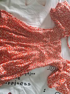 Orange Peplum Top With White Flowers