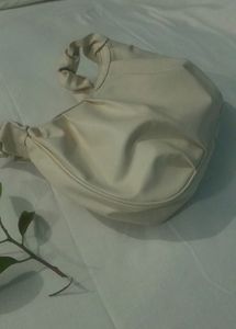 A Beige Side Bag.