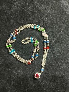 White metal chain with colourful pearls.