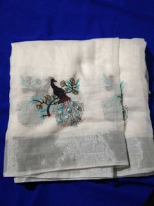 A Beautiful White Saree With Picococks Design