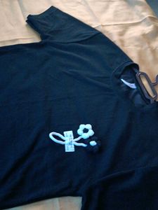 Black top with a knitted flower for women