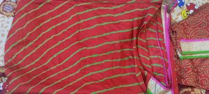 Bright red Gujarati leheriyu saree with pink and green border lace with blouse