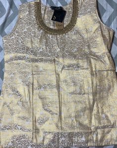 A Traditional Gold Top With Beautiful Neck To