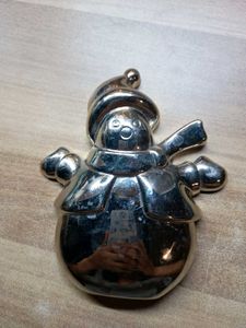 A Shiny Silver Snowman Figurine With Top Hat