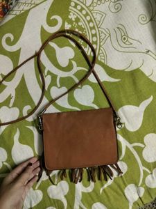 BROWN TASSLED SLING BAG