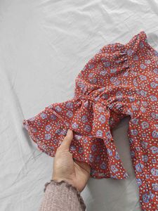 Red top with floral blue pattern