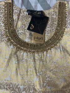 A Traditional Gold Top With Beautiful Neck To