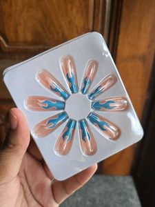 Blue Flame with Nude Nail Extensions