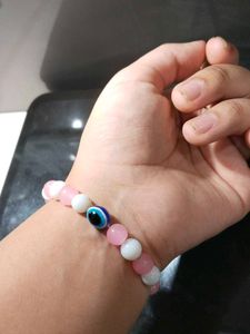 Pink And White Bracelet With An Evil Eye In It