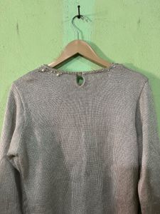 silver sweater with pearl and beaded embellishment