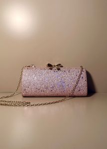 rose‑gold glitter box clutch with bow clasp, chain