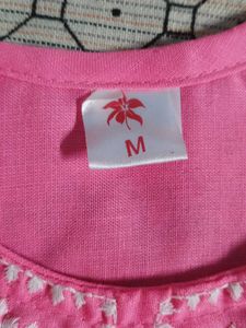Traditional pink kurti with white embroidery.