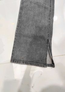 A lightly washed charcoal grey boot cut jeans