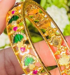 Elegant Gold Bangle with Green and Pink Stones