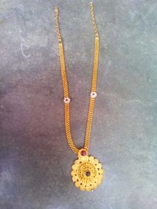 Intricate Gold Tone Filigree Necklace with Red Sto