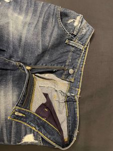 Distressed Mid-Wash Levi’s Jeans”