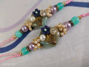 Set Of 2 Rakhis In Pastel Shade With Heavy Stone