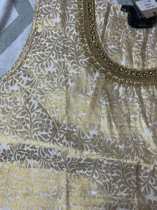 A Traditional Gold Top With Beautiful Neck To