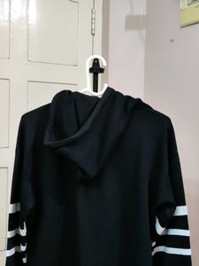 💥BUY1GET1💥 black hooded sweatshirt with white stripes on the sleeves.