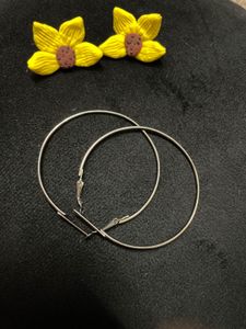 large silver-toned hoop earrings.