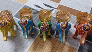 set of five elephants with diya on it