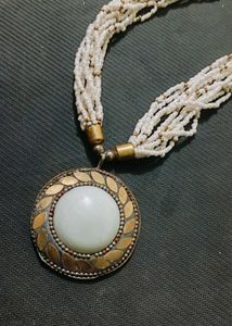 A Black Necklace along With White One