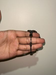 Diamond earrings with black beaded bracelet