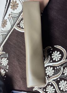 This is a taupe faux leather makeup bag