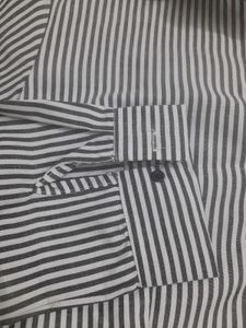 An Elegant Dress With Grey Stripes On White Base