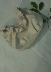A Beige Side Bag.