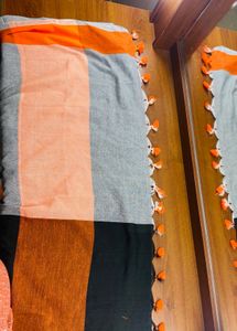 Black orange cotton blend saree with pompoms