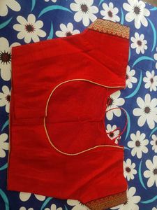 A Light Organe Saree With Red Broad Embroidery