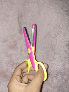 A scissor for cutting Designed Border of paper