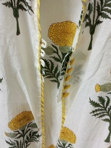 White Kurti with flower design. Can Be worn as shrug also. Length - 46in.