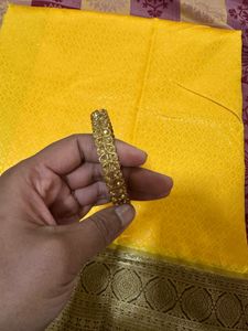 Elegant Yellow Art Silk Saree With A Classy Bangle