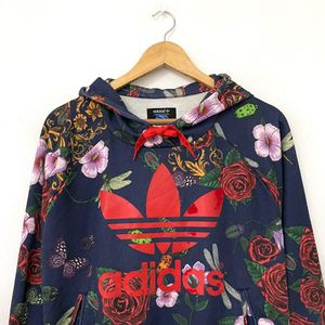 This is an Adidas x Rita Ora navy floral pullover