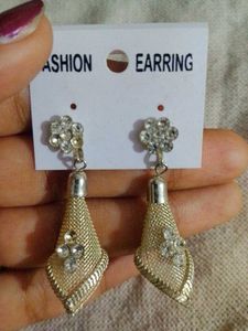 a pair of silver-toned, textured dangle earrings.