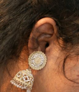 A Beautiful Gown With White Earrings