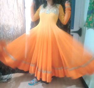A very pretty orange and yellow double shaded full flayar anarkali with chudidar and pretty orange dupatta