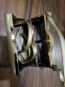Gold Hand  Bag With Removable Sling And 2 Zip Pockets Inside. One In Center And One On Side