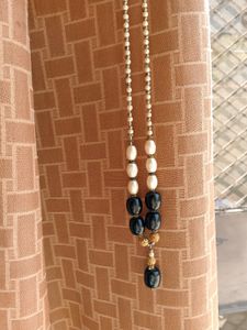 A Black nd White Pearl Necklace With Golden Work