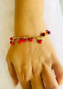 GOLD CHAIN BRACELET WITH RED &amp; BLACK CHARMS