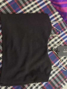 A Black Top With Stones Straps