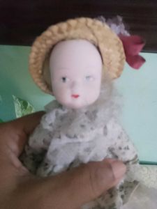 Vintage Porcelain Doll with Straw Hat