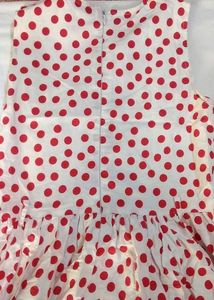 A Beautiful White Frok With Red Polka Dots