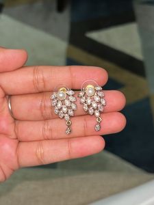 A Set Of Gold Coated Dollar &amp; Earrings