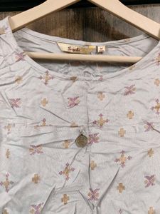 Patterned Sleeveless Top With Dipped Hem