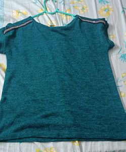 Green Top With Work On It's Shoulder