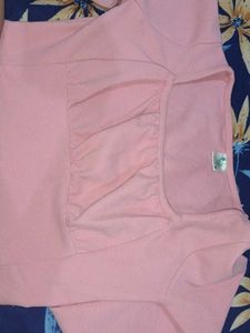 a pink top