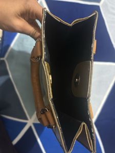 Louie’s Vitton patterned mini handbag